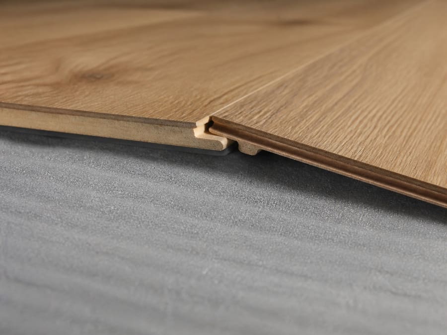 Laminate planks clicking together over foam underlayment in a ground floor room