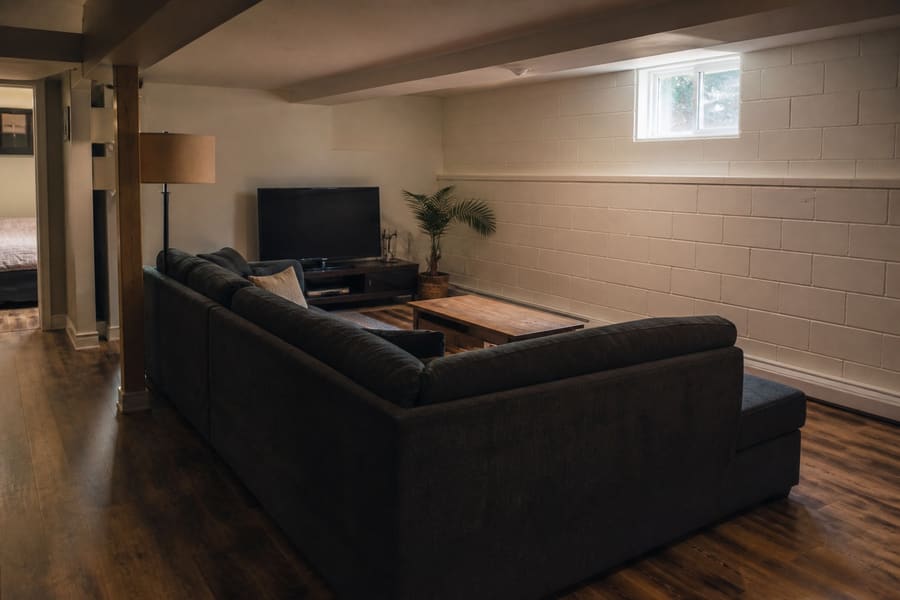A finished basement room in a Staten Island house with a hard wearing plank floor